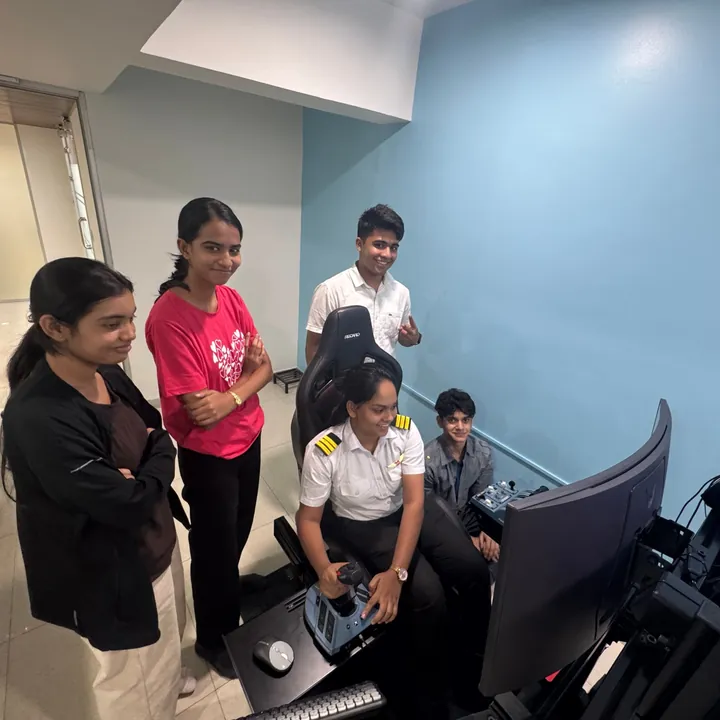 Students gathered around the flight simulator station at Aerogenesis Bangalore