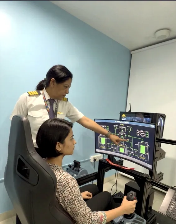 Capt Vidhi Sharma briefing a student at the Aerogenesis flight simulator