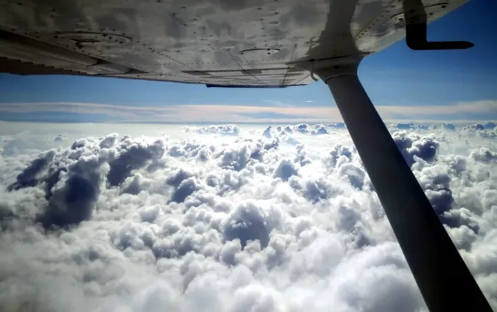 Cockpit view above the clouds during flight training