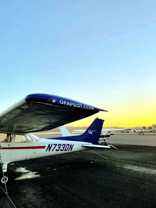 Training aircraft parked at sunset