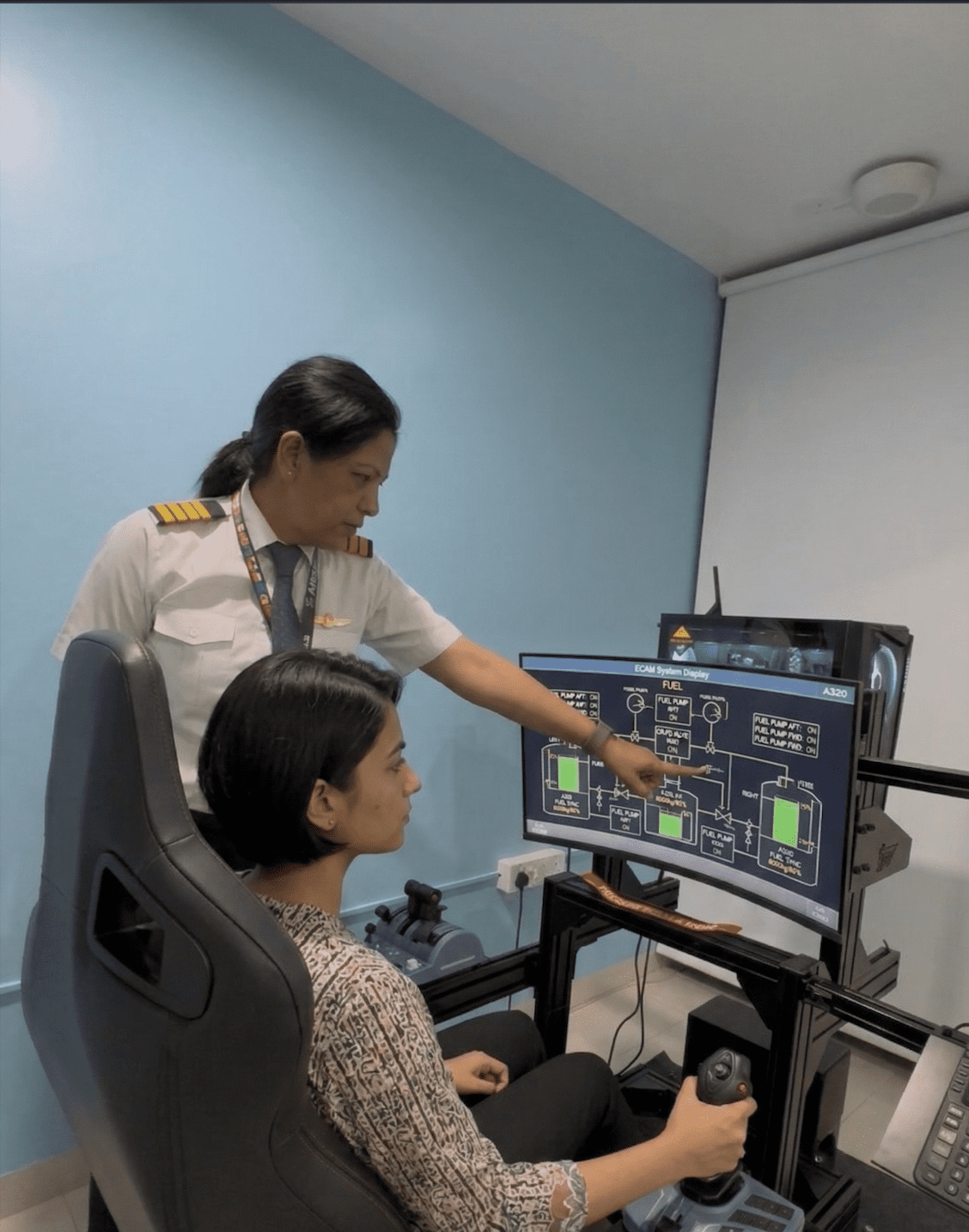 Captain vidhi sharma teaching student on a320 ecam fuel system display