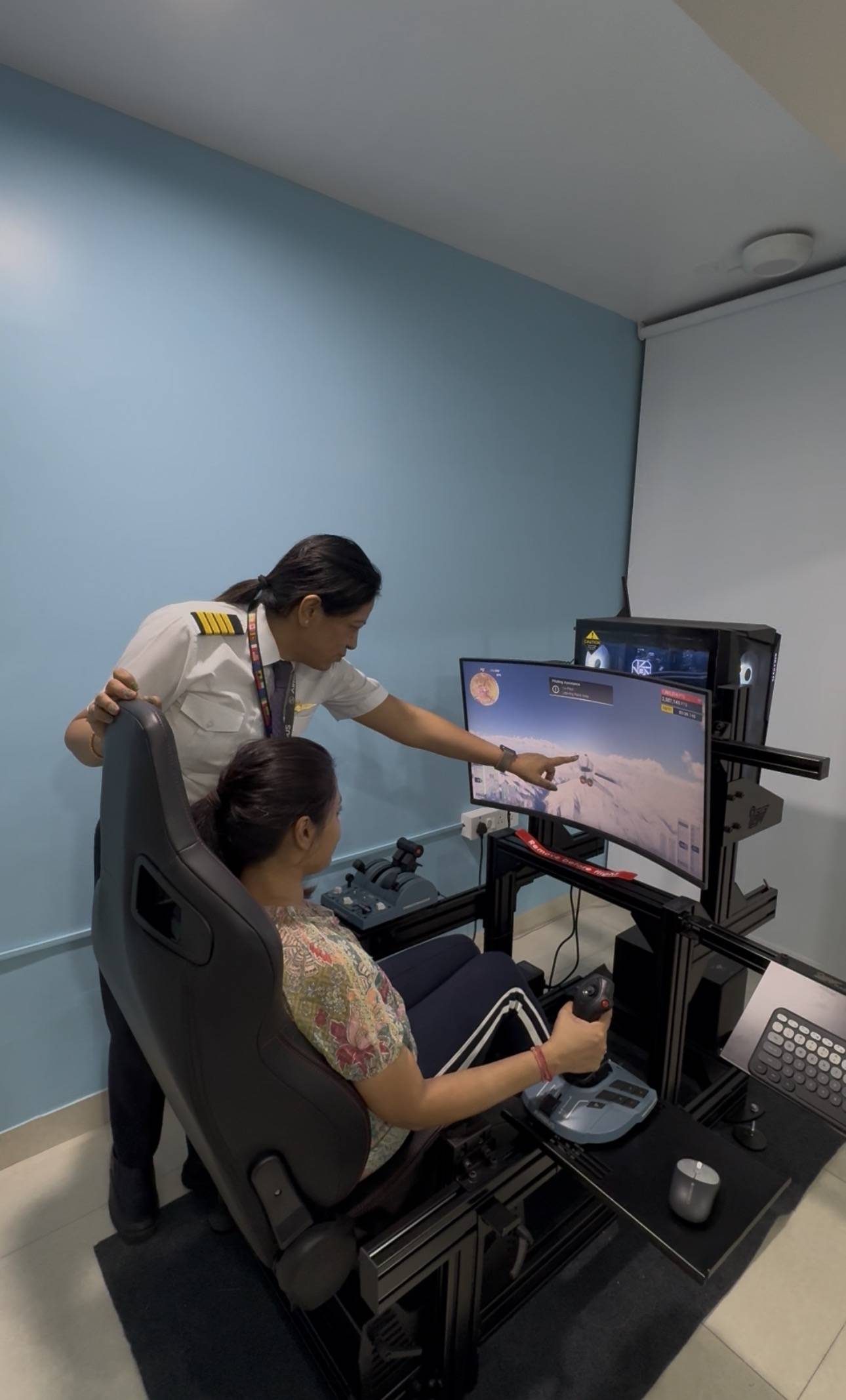 Captain vidhi sharma guiding student through flight simulator session